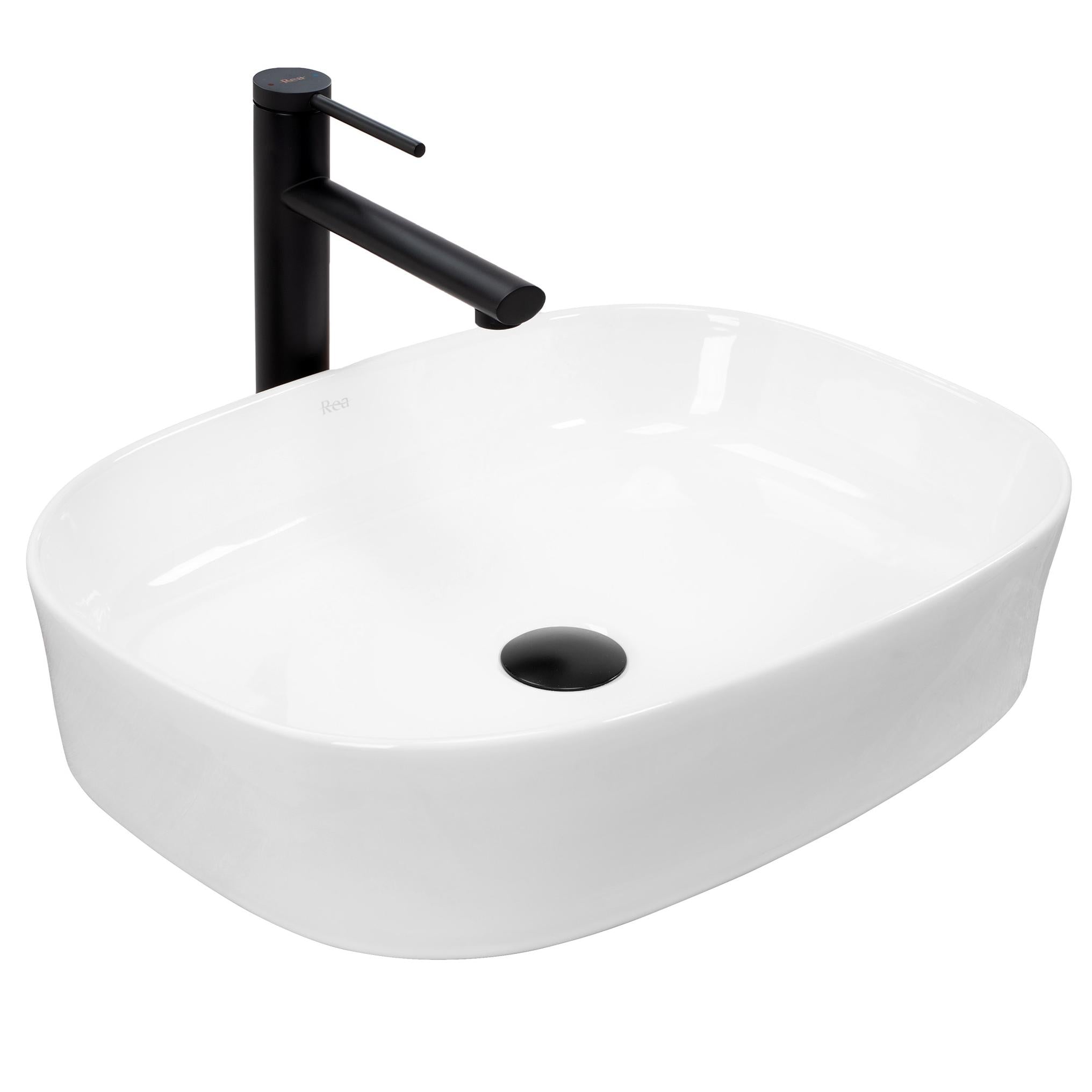 Modernes Aufsatzwaschbecken Rea Angie in strahlendem Weiß, mit geometrischer Form und sanft angehobenen Rändern, auf einer Badezimmerplatte platziert.
